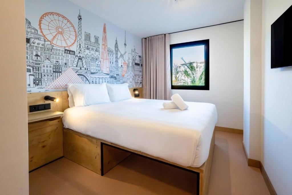 a bedroom with a large bed in a room at easyHotel Alicante Centro in Alicante