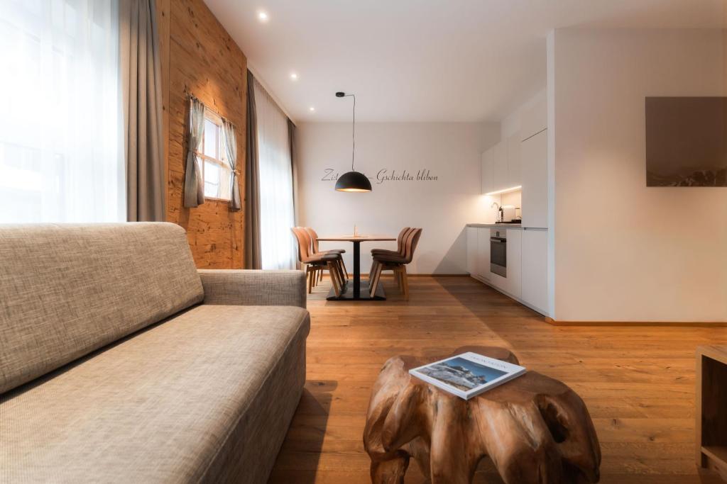 a living room with a couch and a table at adler alpen apartments in Schruns
