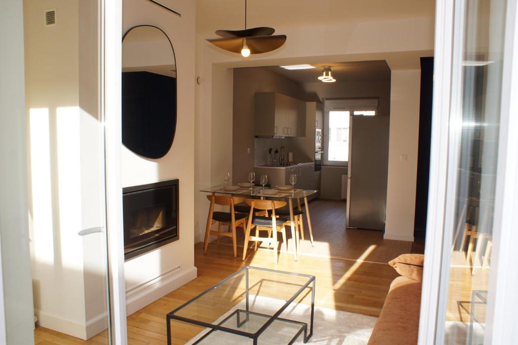 a living room with a table and a dining room at Cocon de Charme - T2 sur Place d'Armes in Valenciennes