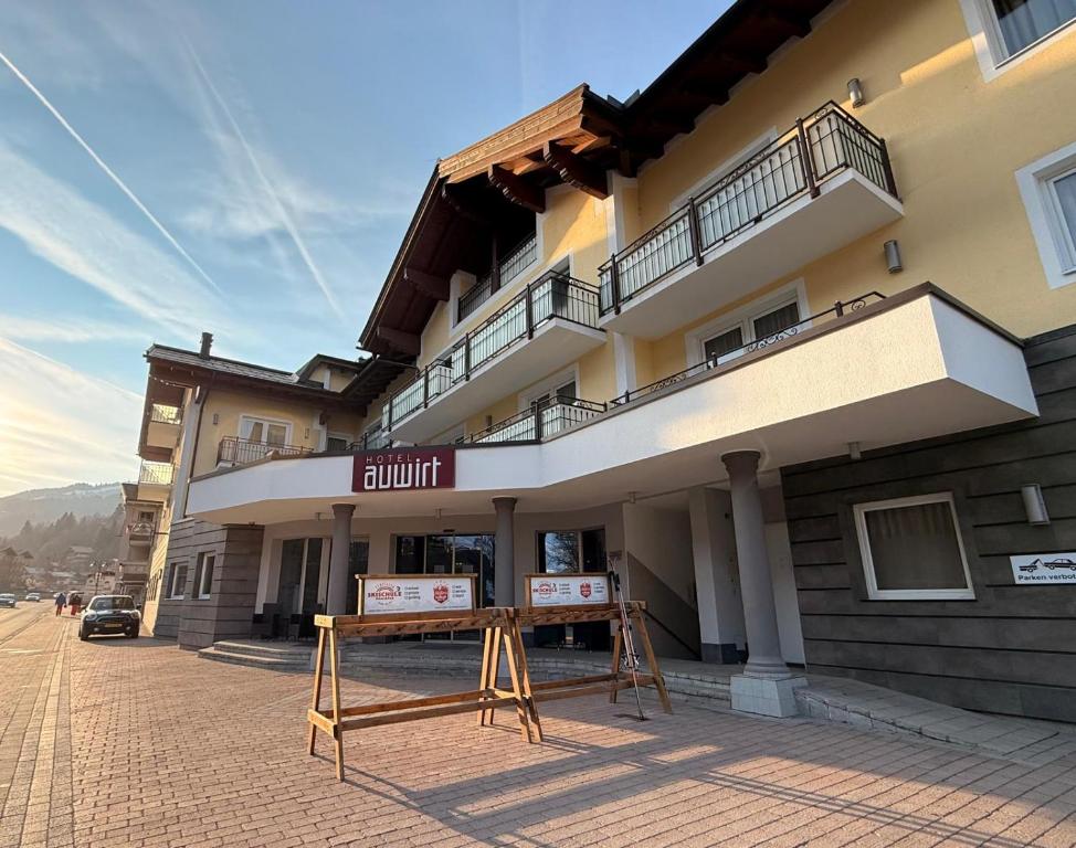 a building with a sign in front of it at Hotel Auwirt Zentrum in Saalbach-Hinterglemm