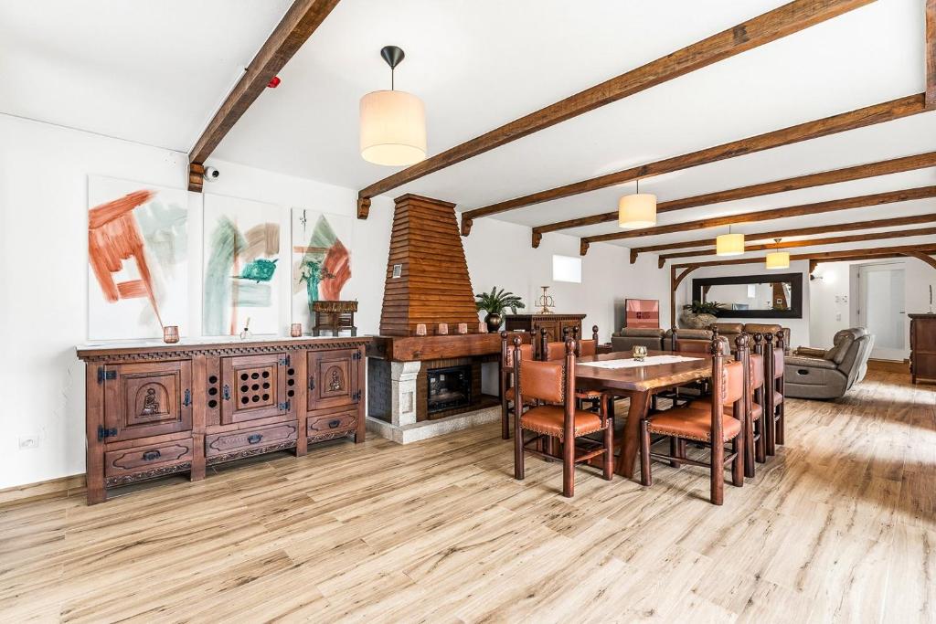 a dining room with a table and a fireplace at GuestReady - Quinta da Devesa in Vila Nova de Gaia