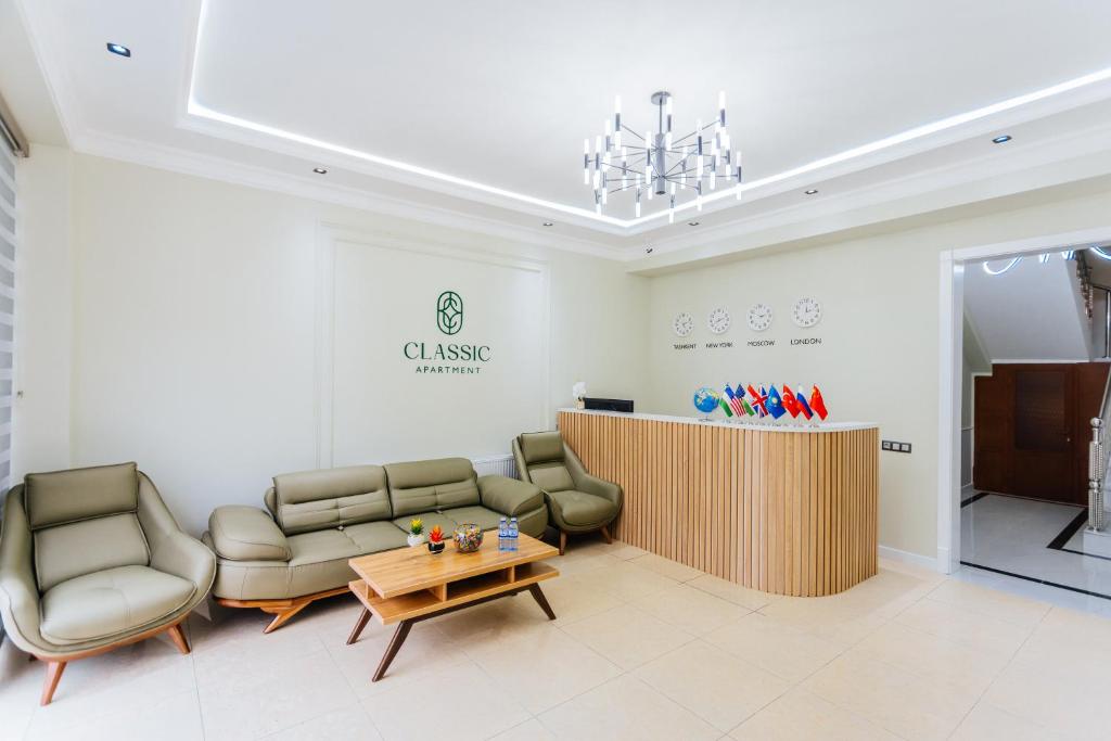 a waiting room with couches and a table and chairs at Classic Hotel Samarkand in Samarkand
