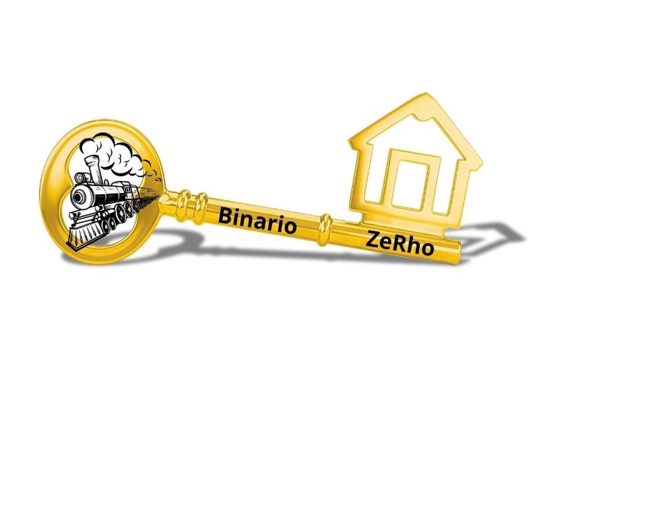 a yellow gold skeleton key with a house on it at BINARIO ZERHO Luxury Apt in Rho