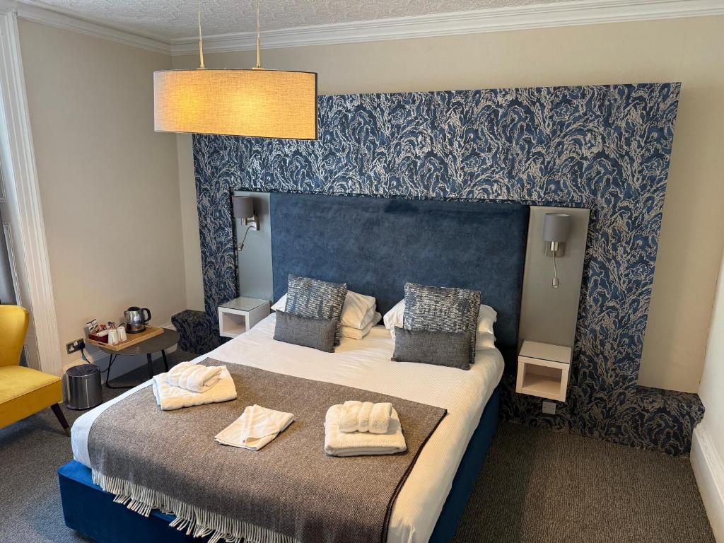 a hotel room with a bed with towels on it at Royal Sportsman Hotel in Porthmadog