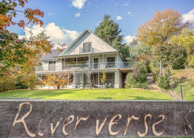 a large house sitting on top of a yard at River Verse in Porepunkah