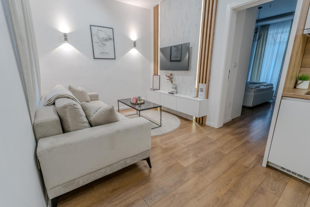 a living room with a couch and a table at Mona Luxury Apartments - Free Garage Parking in Sarajevo
