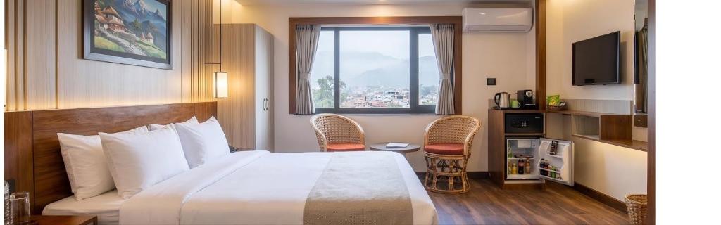 a hotel room with a large bed and a window at The Resident Kathmandu in Kathmandu