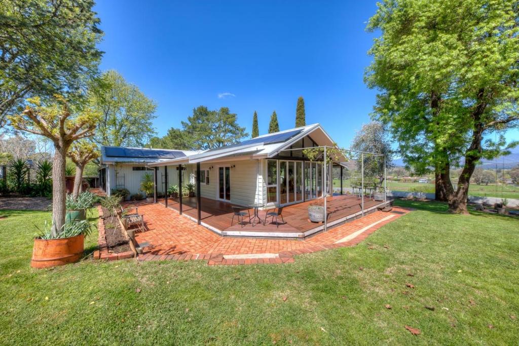 a house with a porch and a yard at Three Pines on Grange in Porepunkah