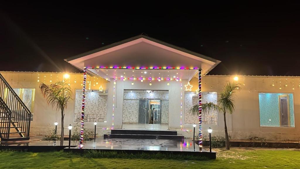 a house with a lit up facade at night at The Golden Farm in Jāmb