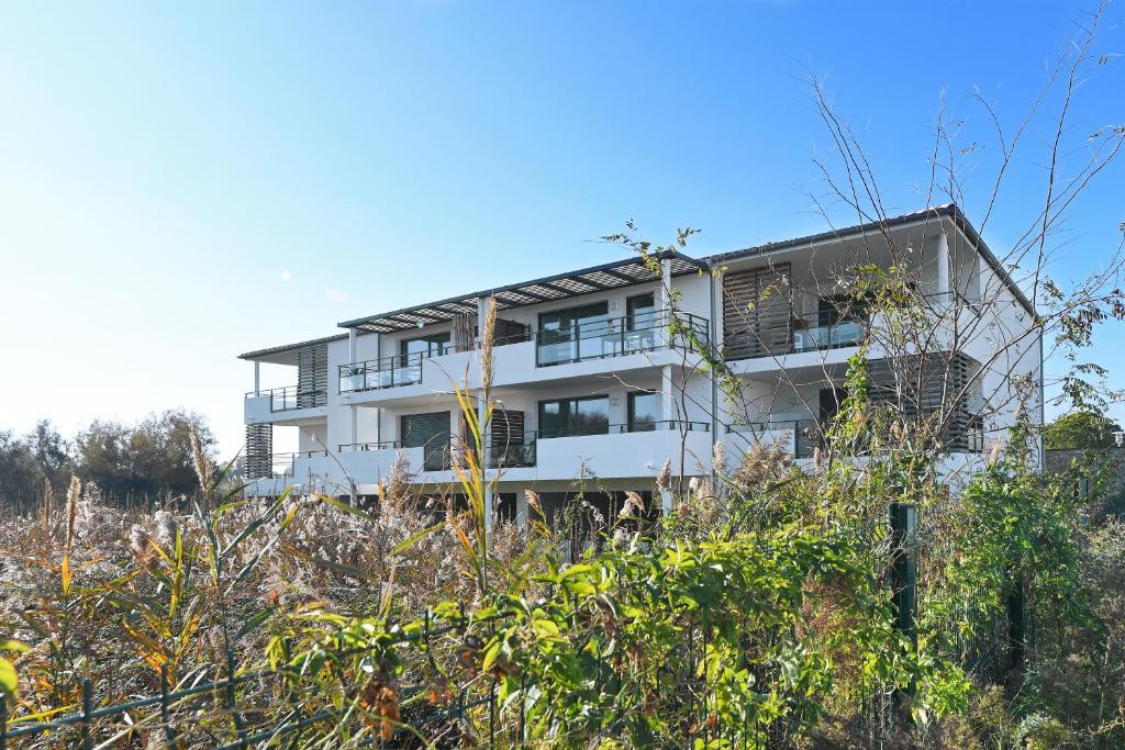 a white building on top of a hill at Appartement de L'Espiguette in Le Grau-du-Roi
