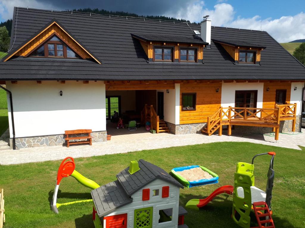 a house with a toy yard in front of it at Chalupa Šalalandia in Zázrivá