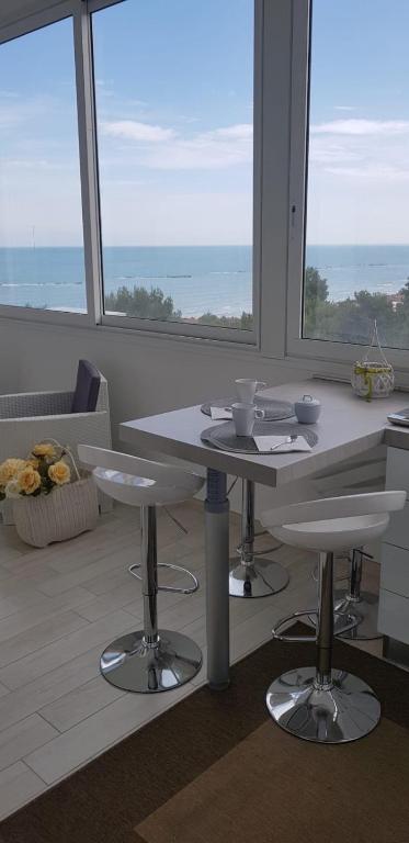 a kitchen with a table and chairs in front of a window at CasAmare in Montesilvano