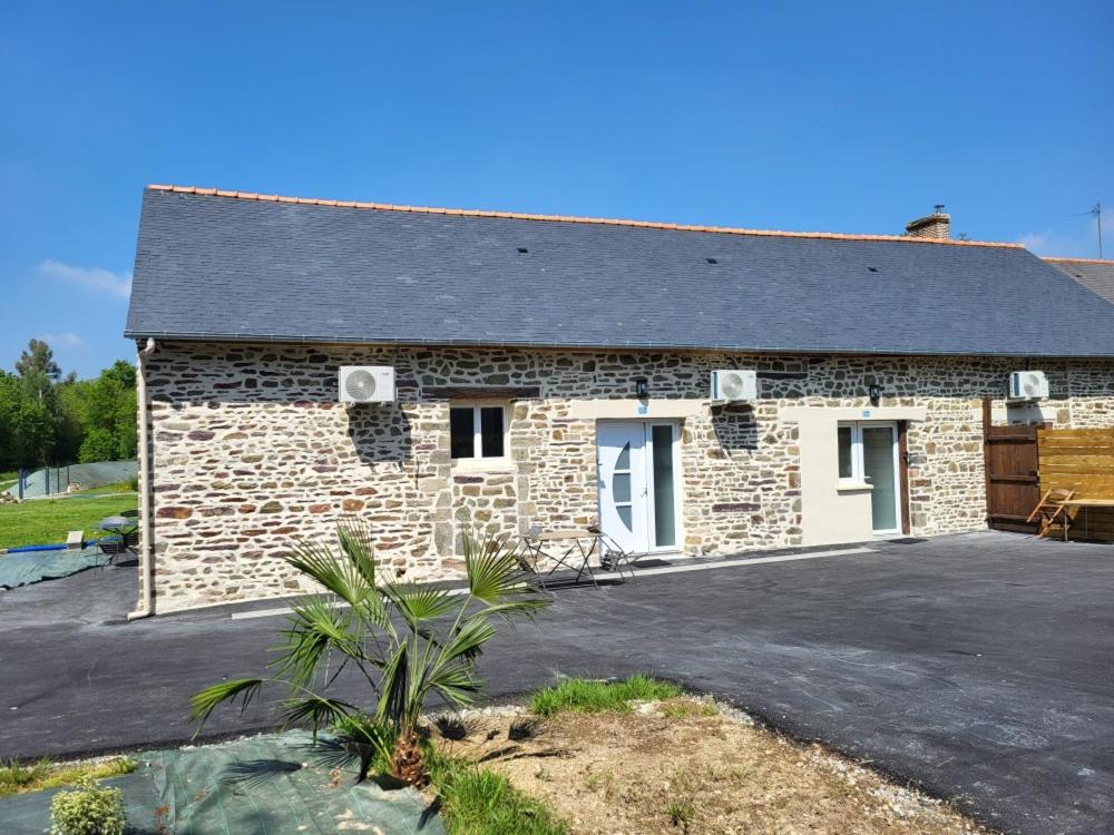 a stone house with a driveway in front of it at Un Bibou de Campagne 3 in Le Theil-de-Bretagne
