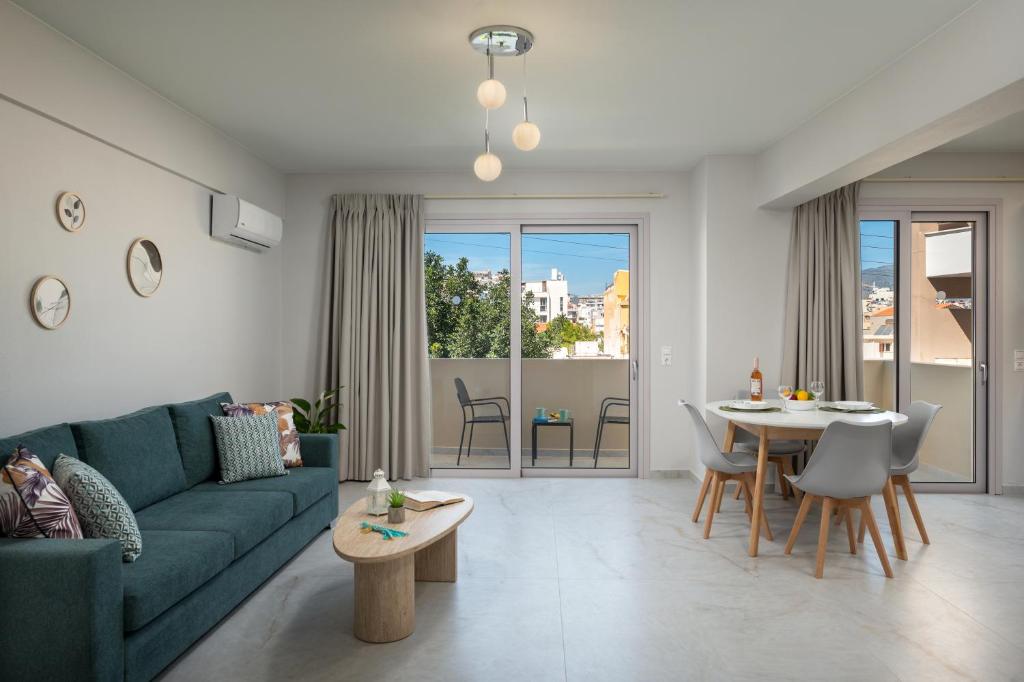 a living room with a green couch and a table at Kamara View Apt 2 in Agios Nikolaos