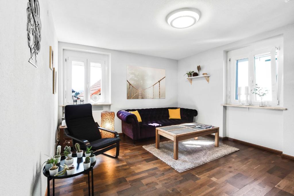 a living room with a couch and a table at Ferienwohnung Südschwarzwald in Wehr