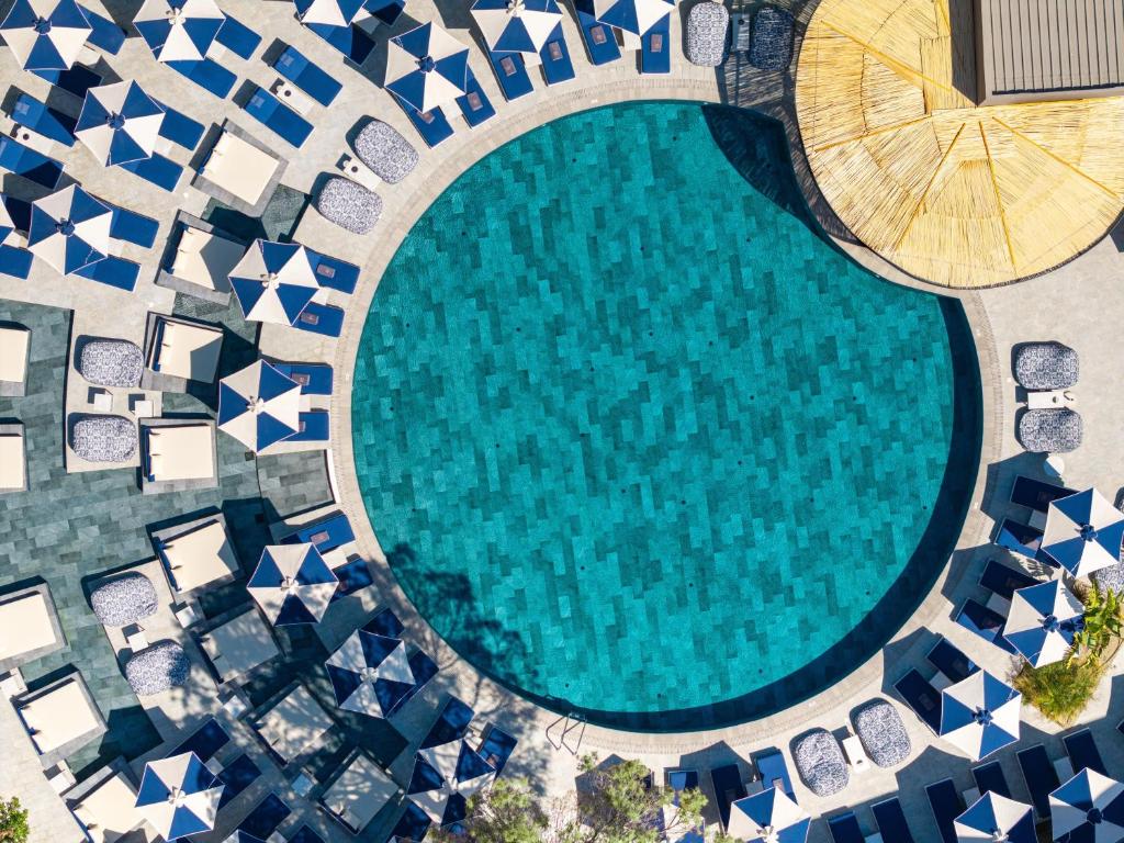 an overhead view of a swimming pool with a sun umbrella at Cabú Hotel Adults Only - Small Luxury Hotels of the World in Faliraki