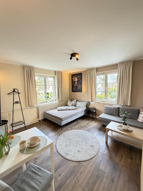 a living room with couches and tables and windows at K10 Living in Karlsruhe