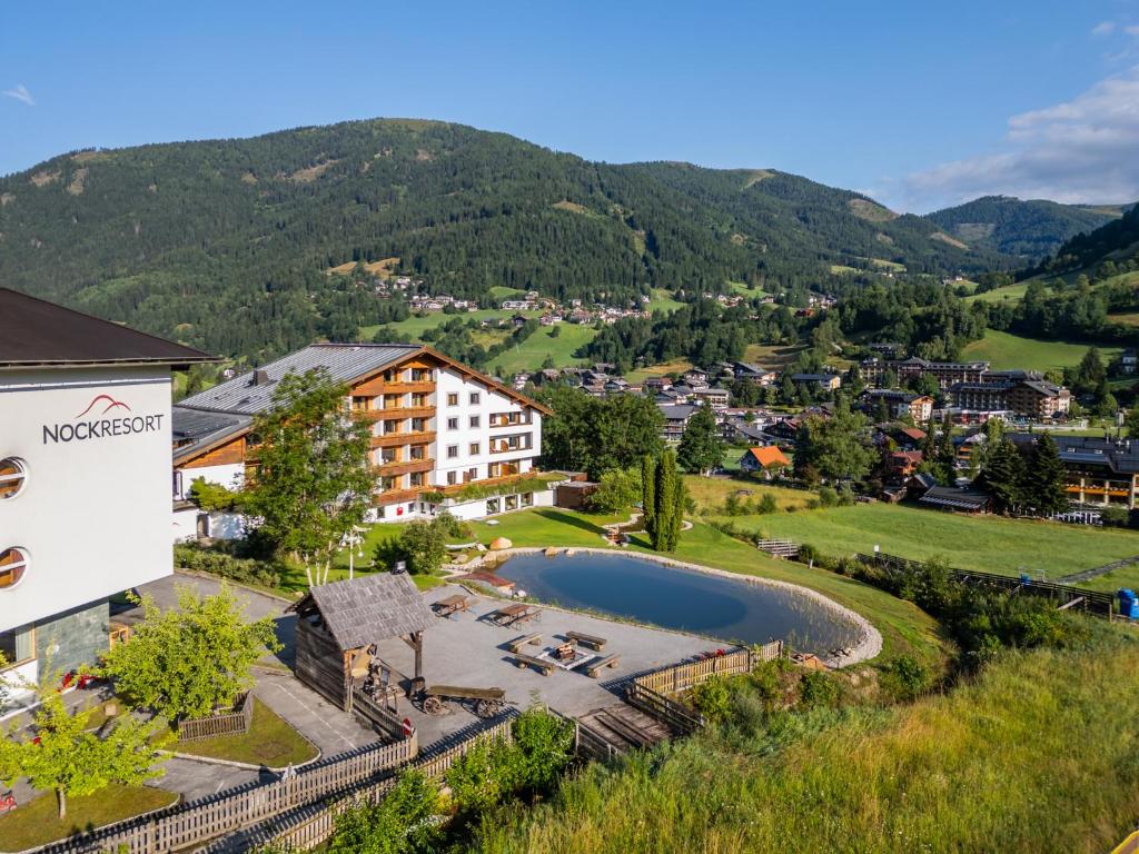 an aerial view of a town with a lake and mountains at Hotel NockResort in Bad Kleinkirchheim