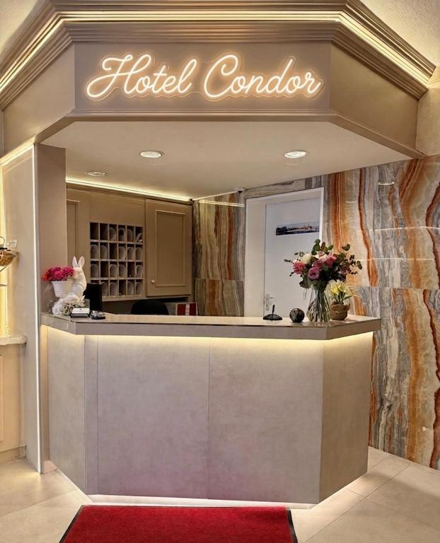a hotel lobby with a hotel controller sign on the wall at Hotel Condor in Hamburg