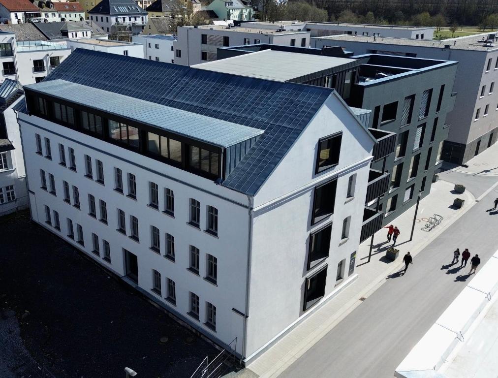 an overhead view of a white building with a solar roof at Alte Weberei in Marktredwitz