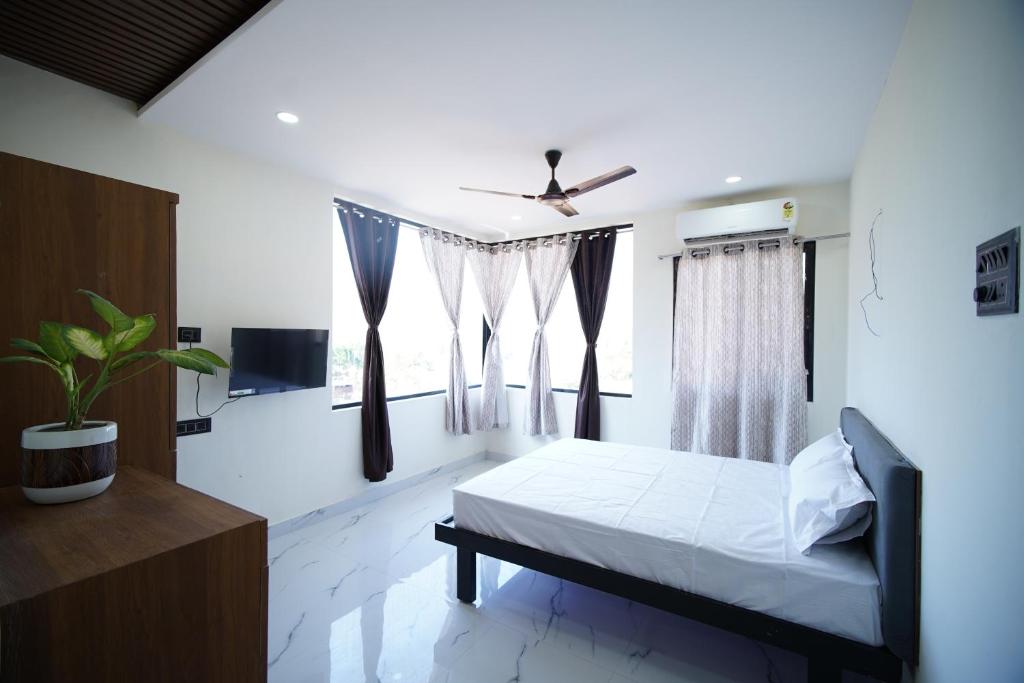 a bedroom with a bed and a window at sinhgad hills in Kharakvasla