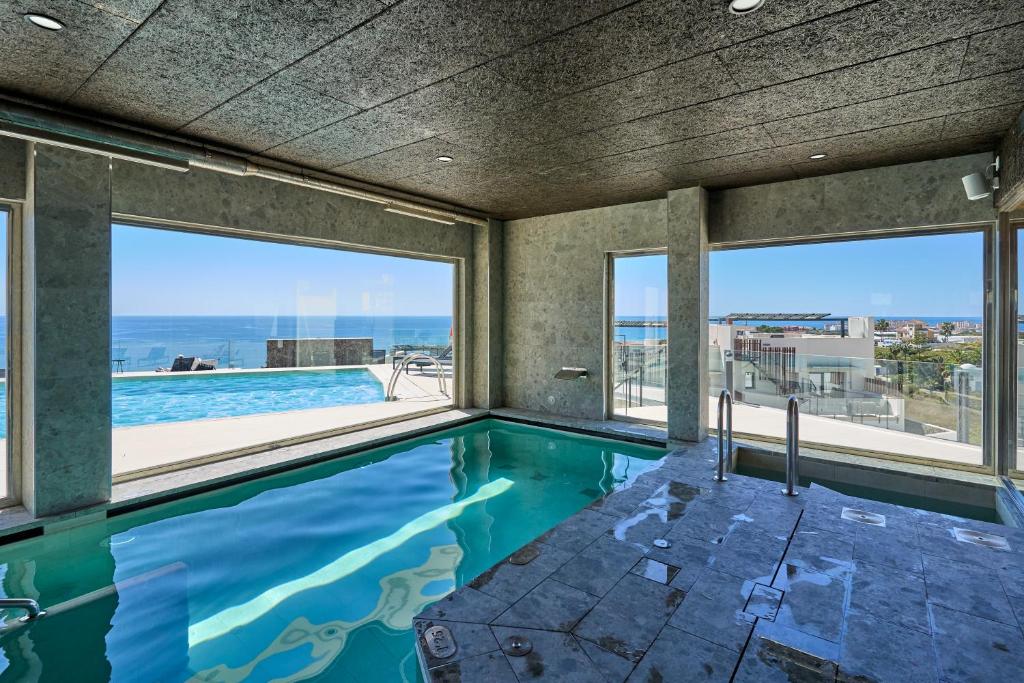 a swimming pool with a view of the ocean at Exclusive Getaway – Ocean View in Torrox Costa