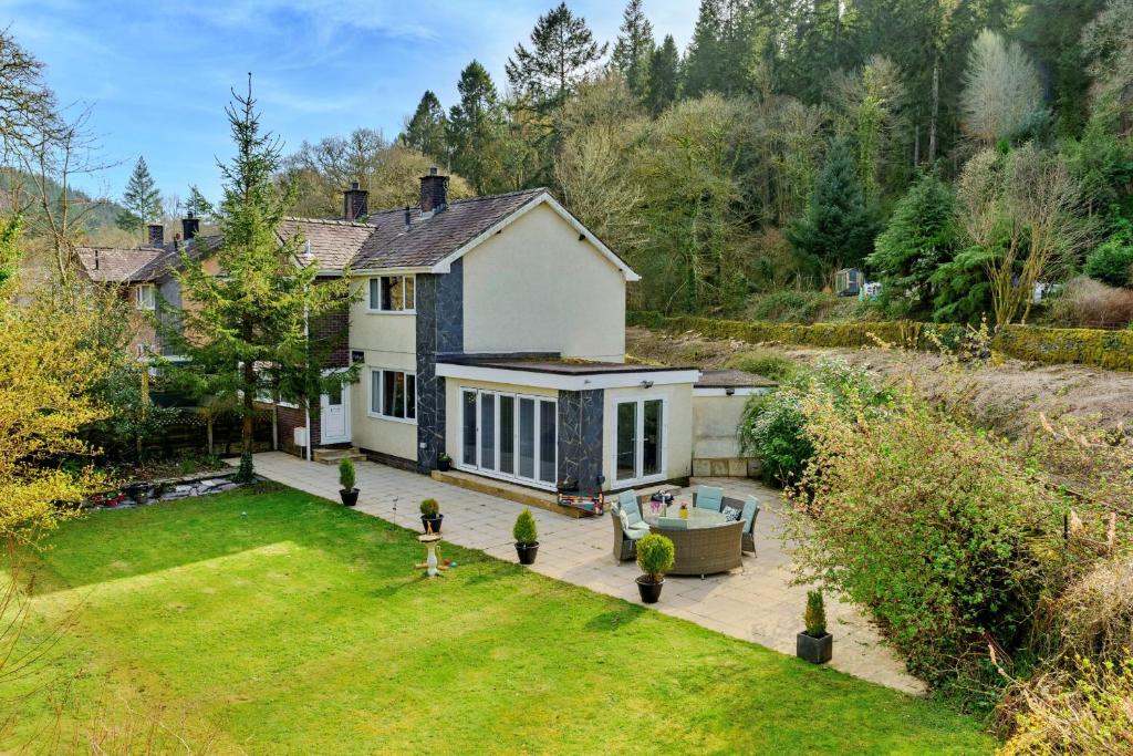 a white house with a yard with a pool at Finest Retreats - Dyffryn in Betws-y-coed