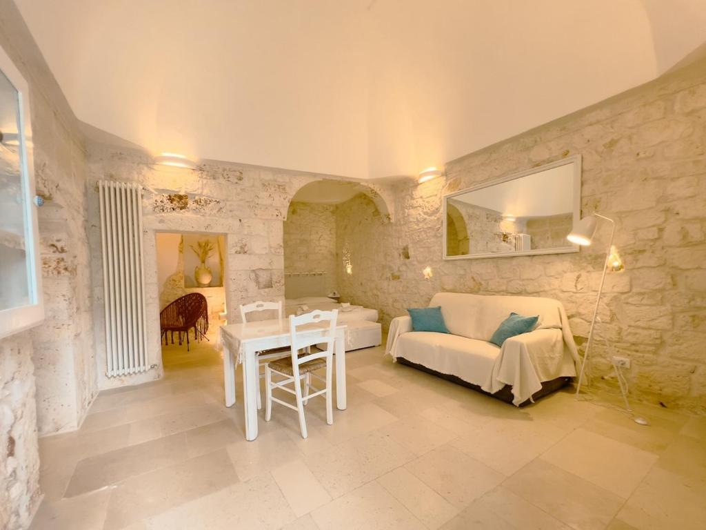 a living room with a couch and a table at Suite Ninfea romantic suite Ostuni center in Ostuni