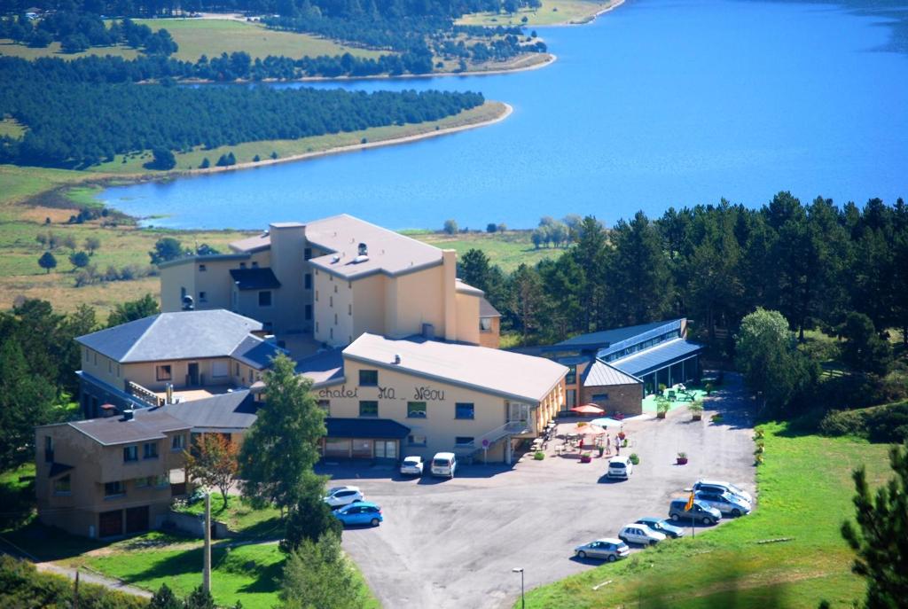 an aerial view of a building with a parking lot at Chalet Ma Neou Village Vacances in Les Angles