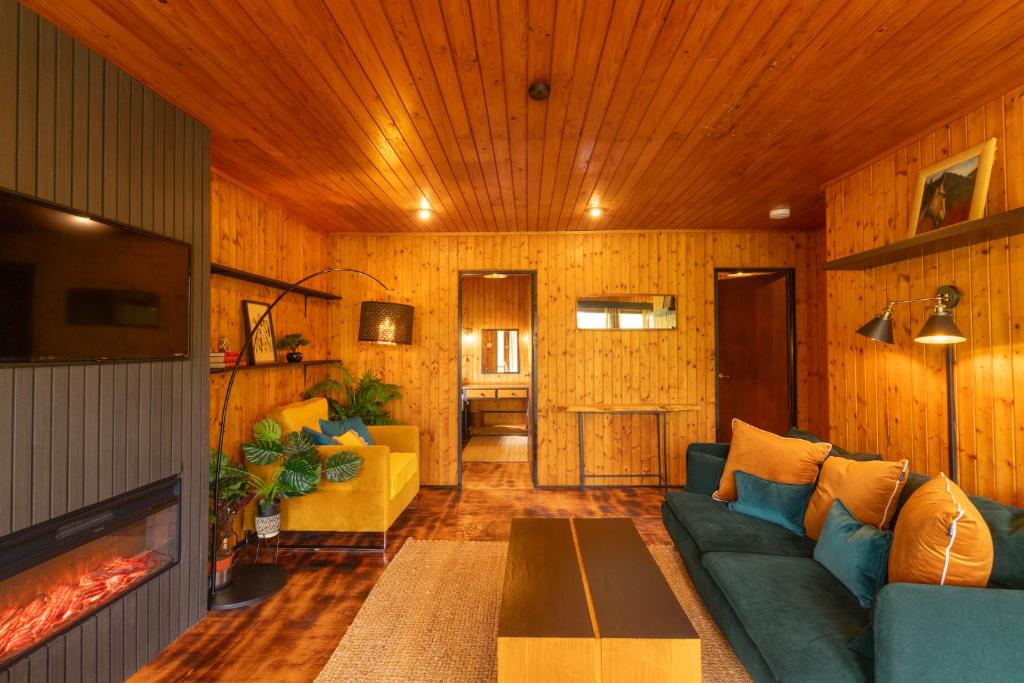 a living room with a couch and a fireplace at Kingswood Pods and Lodges in Fort William