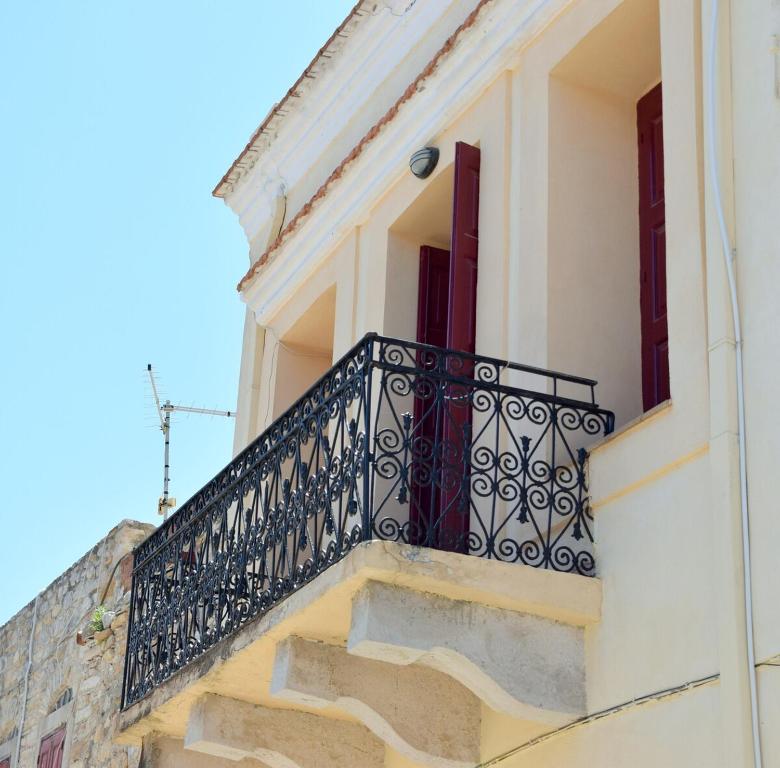 a balcony with a black railing on a building at Traditional Villa Marina in Chios