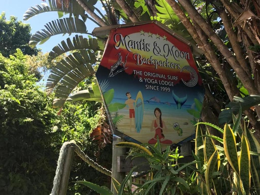 a sign for a beach resort on a tree at Mantis and Moon Surf Paradise & Adventure Lodge in Hibberdene
