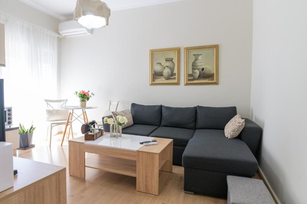 a living room with a couch and a table at BALLET MAISON in the heart of the city in Alexandroupoli