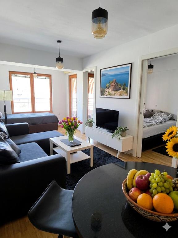 a living room with a couch and a bowl of fruit at Petar Apartment-City Center, Ohrid in Ohrid