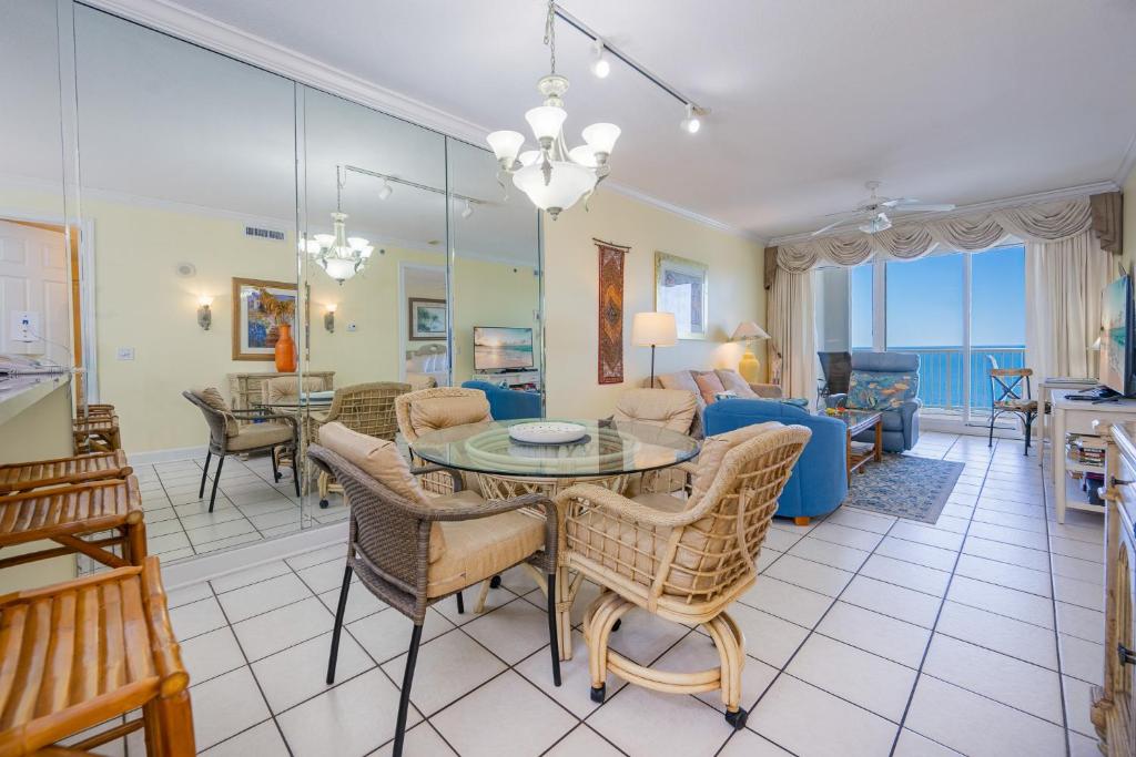 a dining room and living room with a table and chairs at Island Royale 404 in Gulf Shores