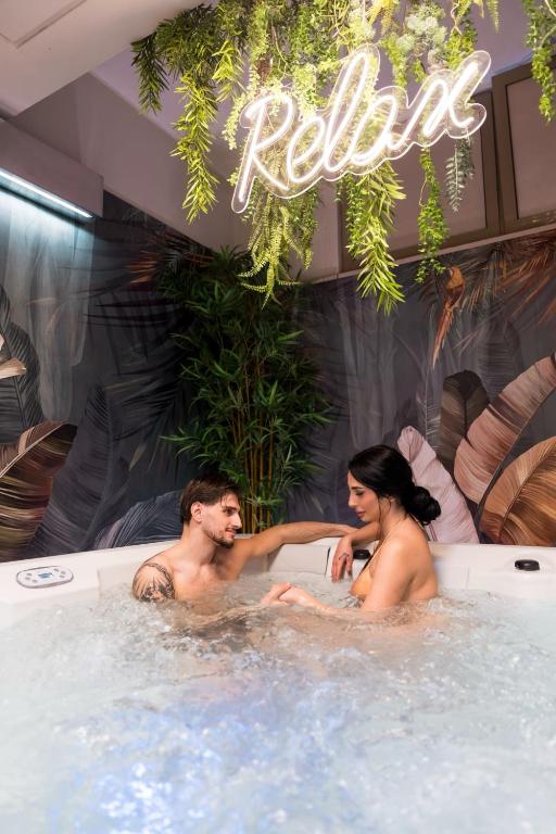 a man and woman sitting in a hot tub at Barone Liberty Boutique Hotel & Spa in Gallipoli