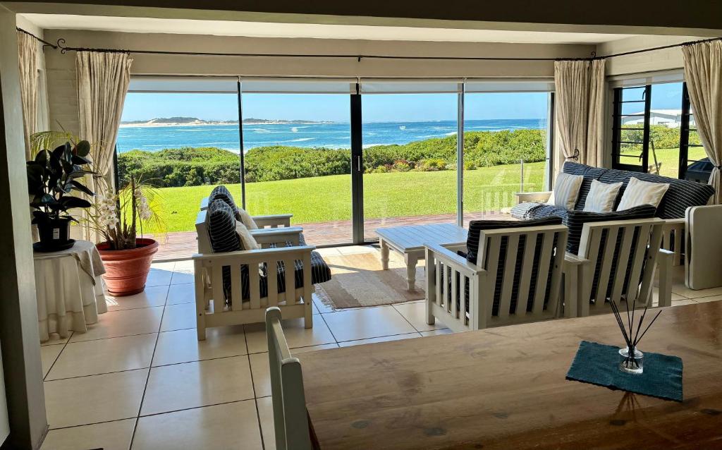 a living room with a view of the ocean at Godolphin beach house in Cape St Francis