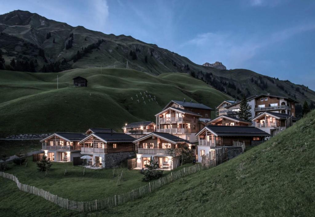 a house on the side of a hill at Aadla Walser-Chalets mit privater Sauna, Hotpot und Hotelservice in Schröcken