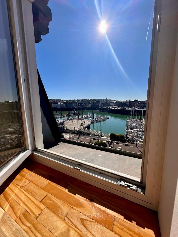 a large window with a view of a harbor at Le Champlain Duplex Port de plaisance in Dieppe