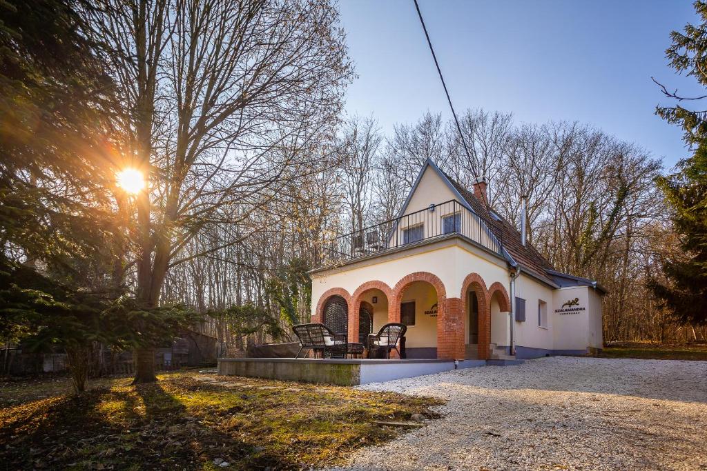 a white house with the sun shining on it at Verőce-Szalamandra vendégház Hrsz 6905 in Kismaros