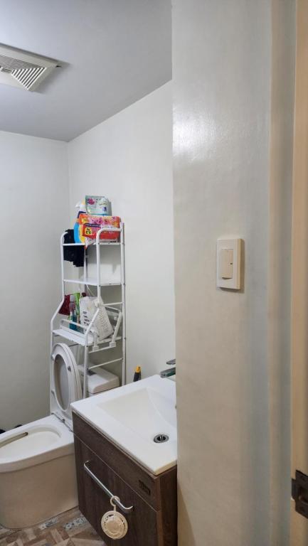 a bathroom with a sink and a toilet in a room at Condo Minsorado in General Trias