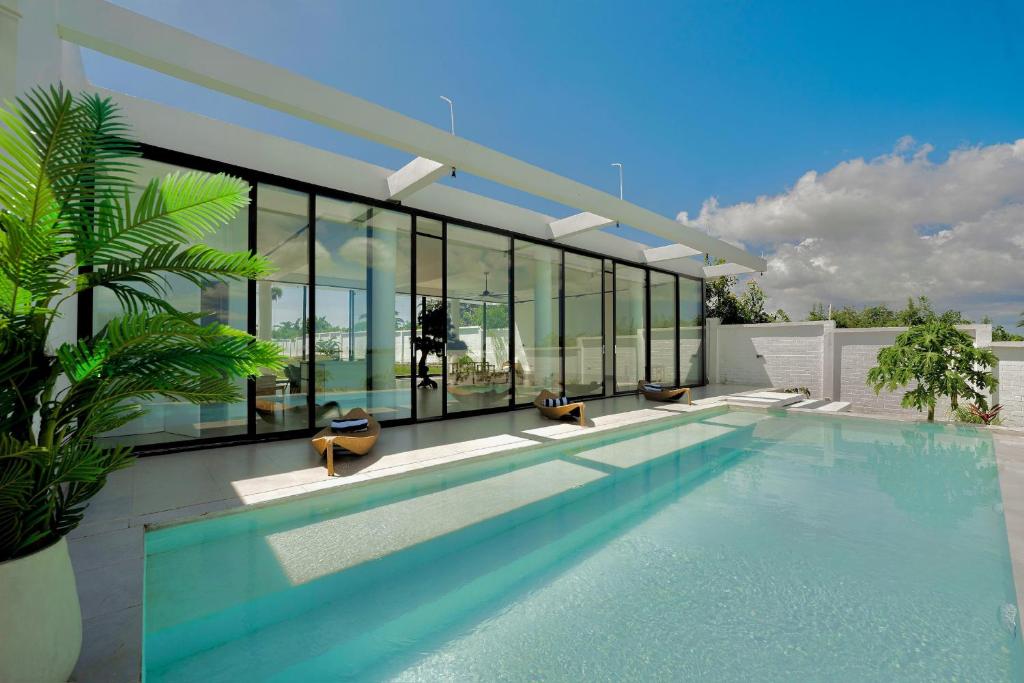a house with a swimming pool with glass walls at Casa Del Mare Ocean SeaView Villa with Private Pool in Zanzibar City