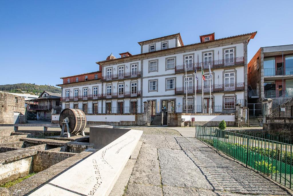 a large white building with a fence in front of it at HI Guimaraes - Pousada de Juventude in Guimarães