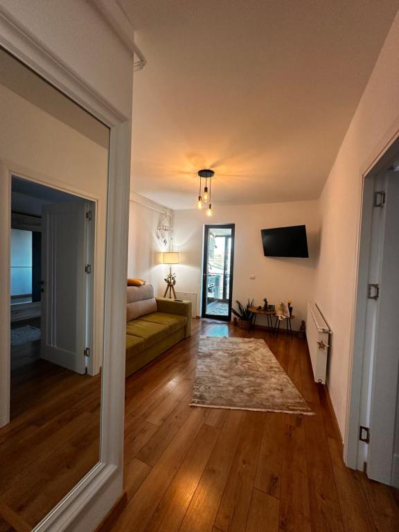 a living room with a couch and a television at Stadium Central Apartment Residence & terrace in Craiova