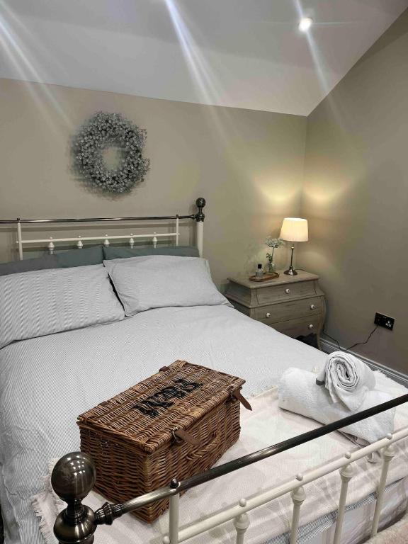 a bedroom with a bed with a basket on it at 86 Galgorm in Ballymena