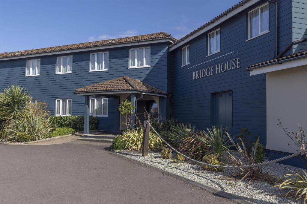 a blue building with a sign that reads more house at The Bridge House; BW Signature Collection in Ferndown