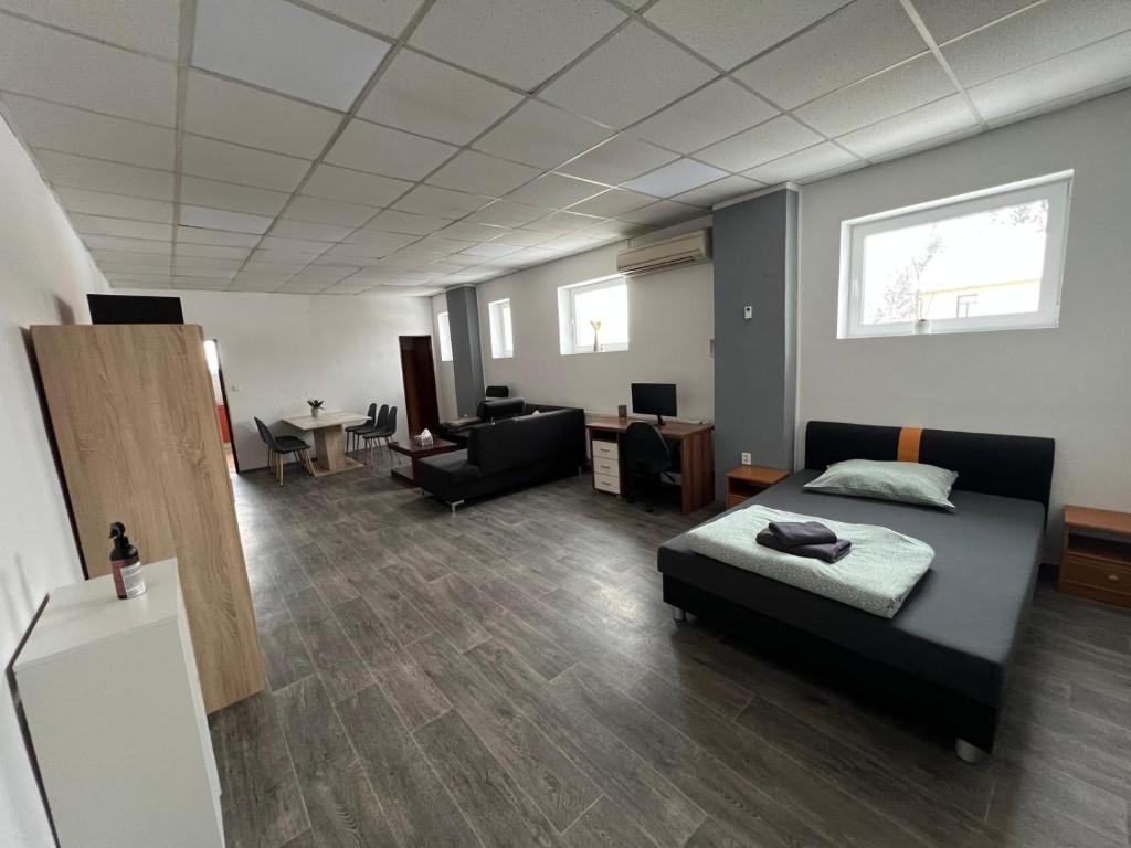 a bedroom with a bed and a living room at Apartmán Na Blatech in Česká Lípa