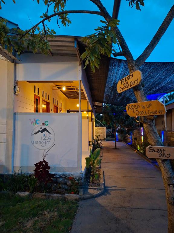 a building with signs on the side of it at Iza home stay in Senaru