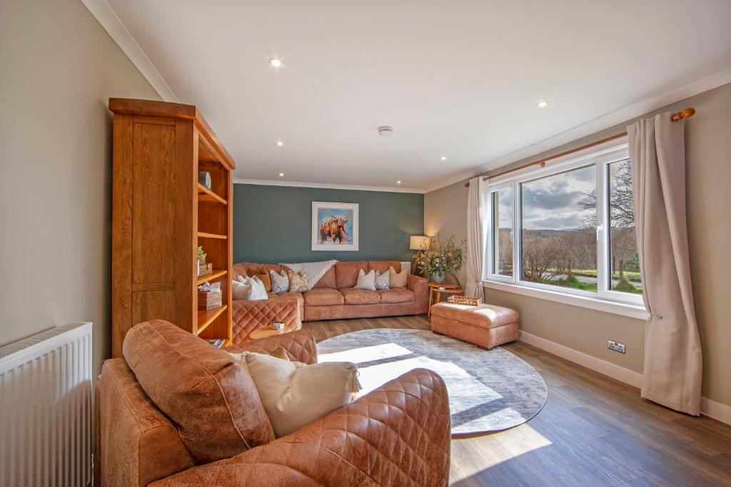 a living room with two couches and a large window at Cuilreigh, North Connel in Oban