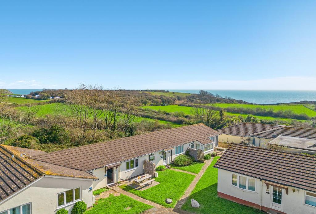 a row of houses with the ocean in the background at Landscove Chalet 19 in Brixham